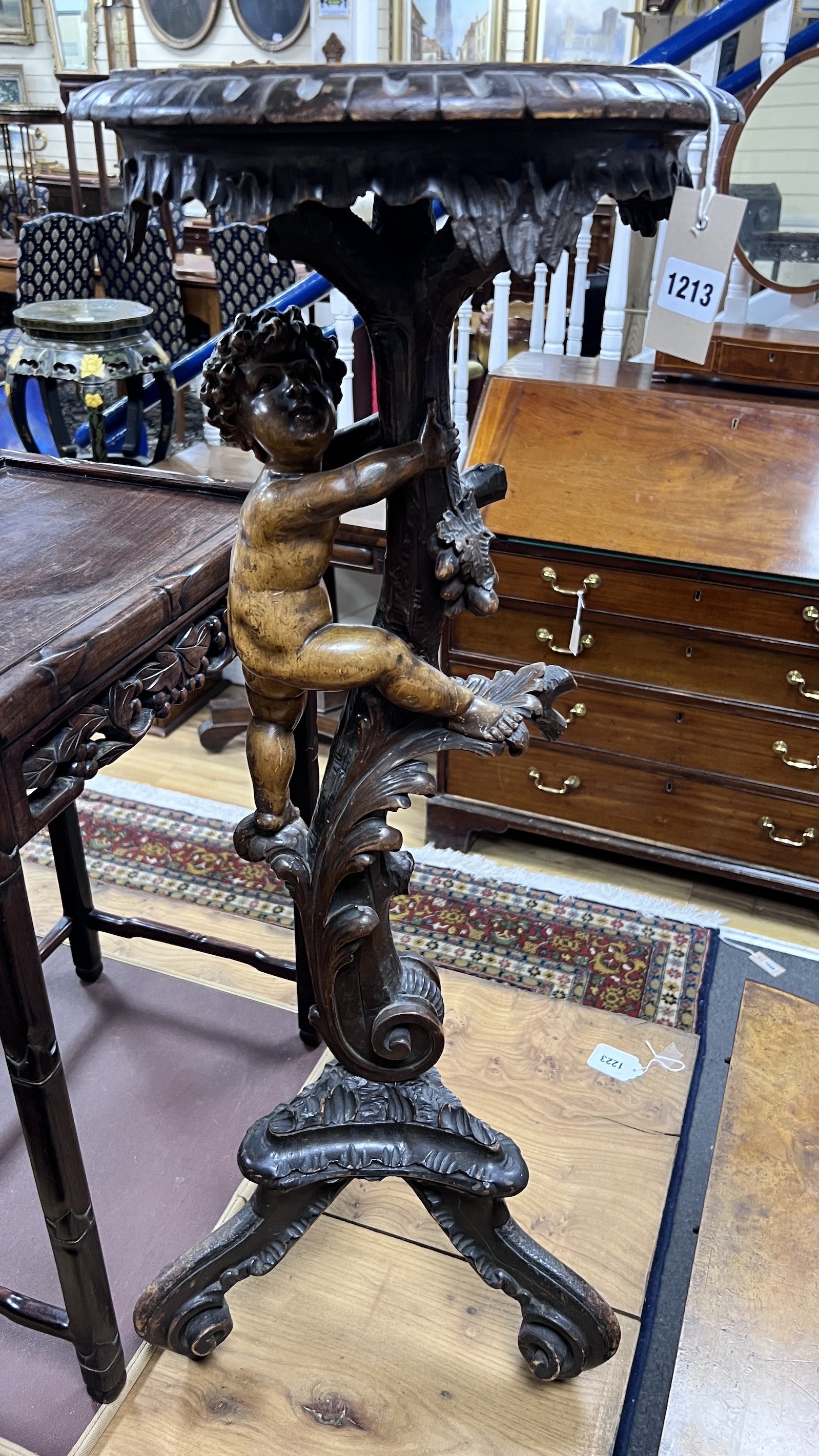 An early 20th century Italian carved walnut and softwood torchere, height 90cm